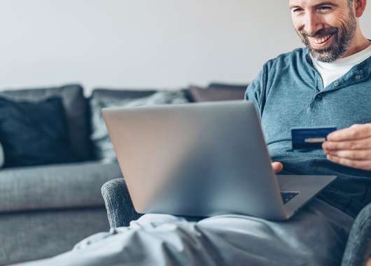 man using credit card on computer