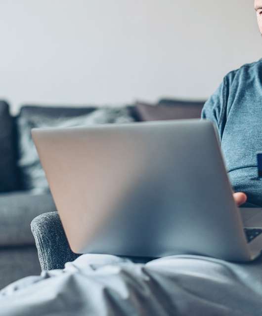 man using credit card on computer