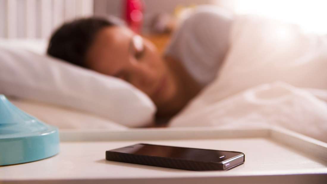 woman sleeping by a phone
