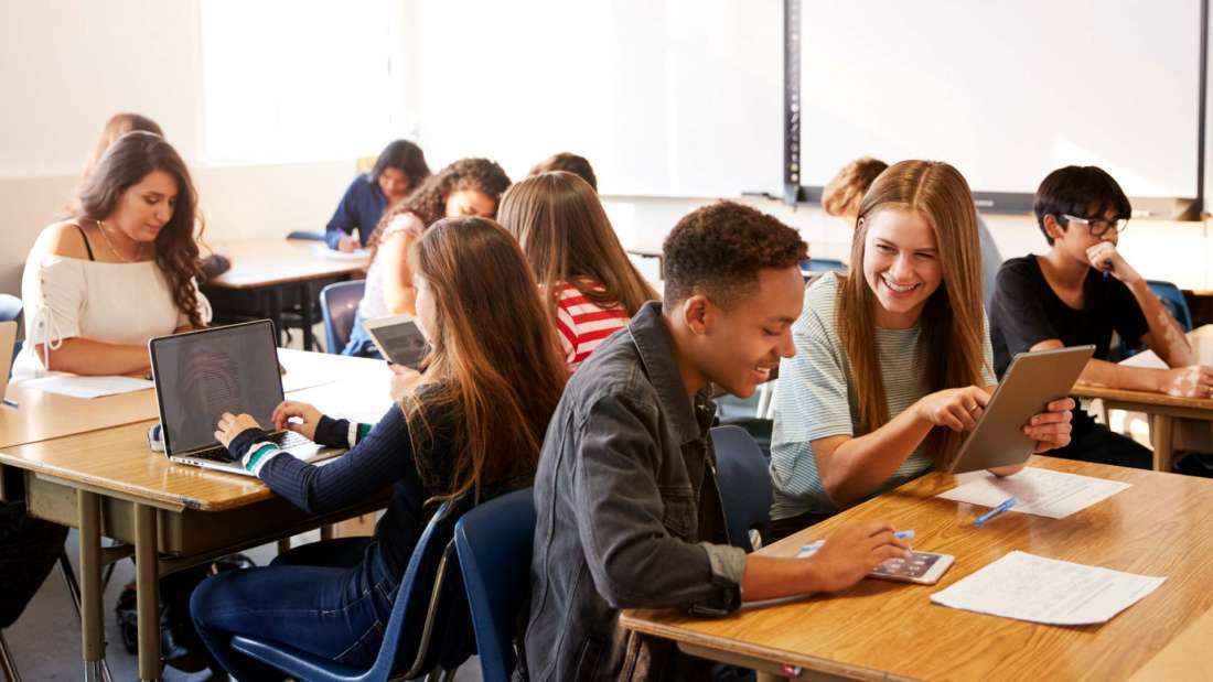 Teen students using edtech in a classroom
