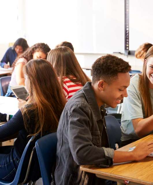 Teen students using edtech in a classroom