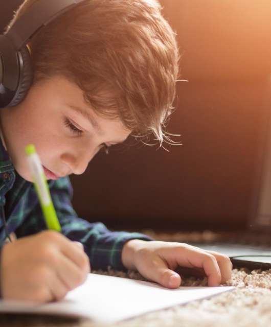 Young-boy-studying-with-tablet-at-home