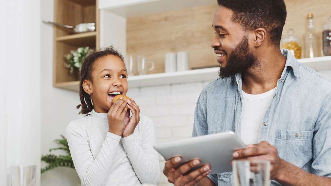 girl-eating-cookie-dad-on-ipad