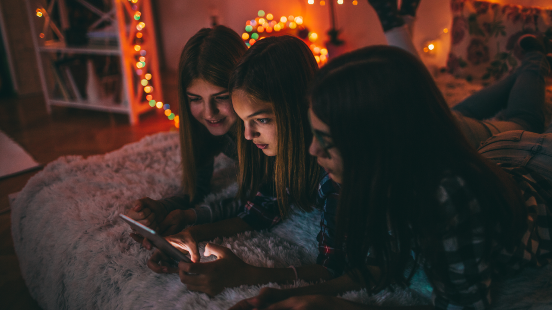 teen-girls-in-room-on-phone-tablet-online-slang