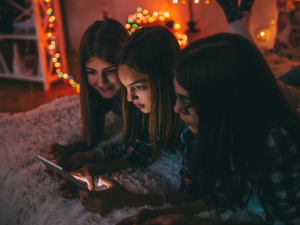 teen-girls-in-room-on-phone-tablet-online-slang