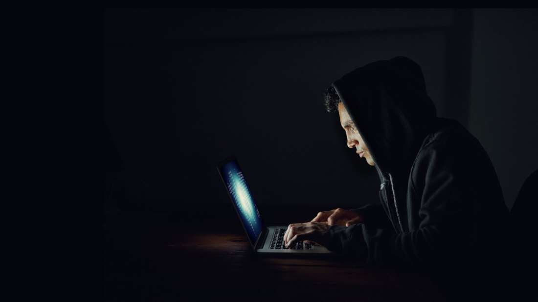 man-hacker-on-laptop-spoofing