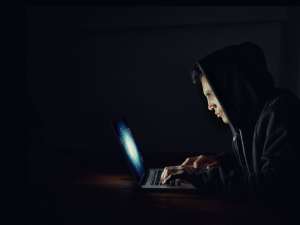 man-hacker-on-laptop-spoofing