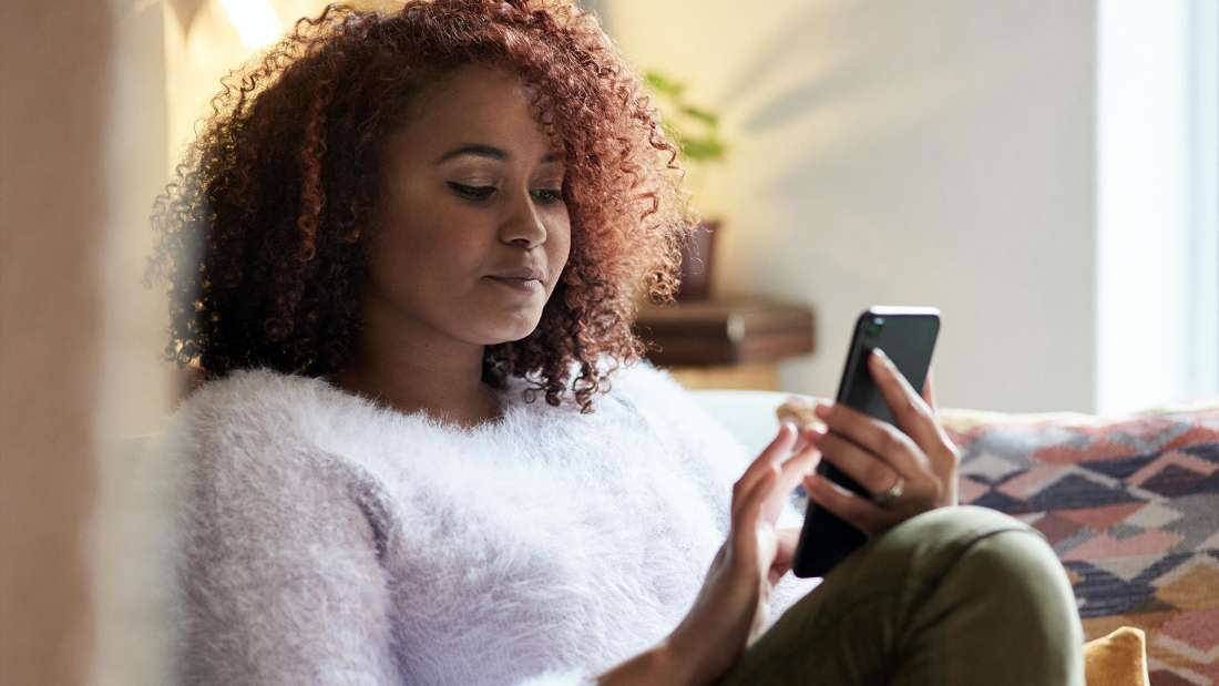 Photo of a person looking at their smartphone