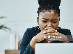 Image of a woman looking at a laptop screen