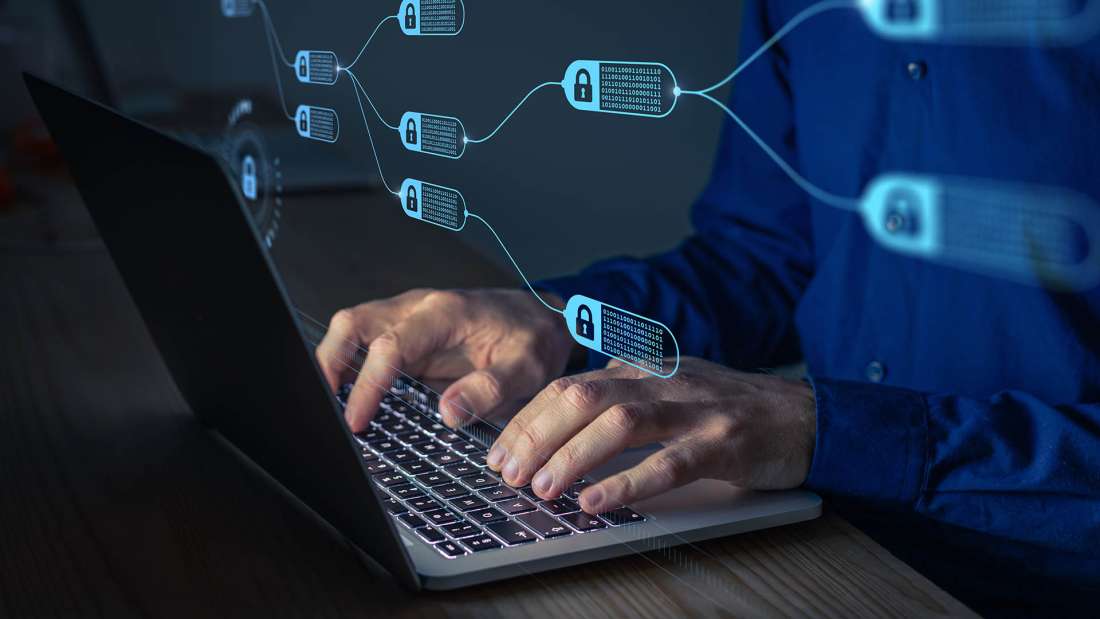 Image of hands typing on a laptop leyboard