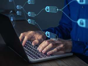 Image of hands typing on a laptop leyboard