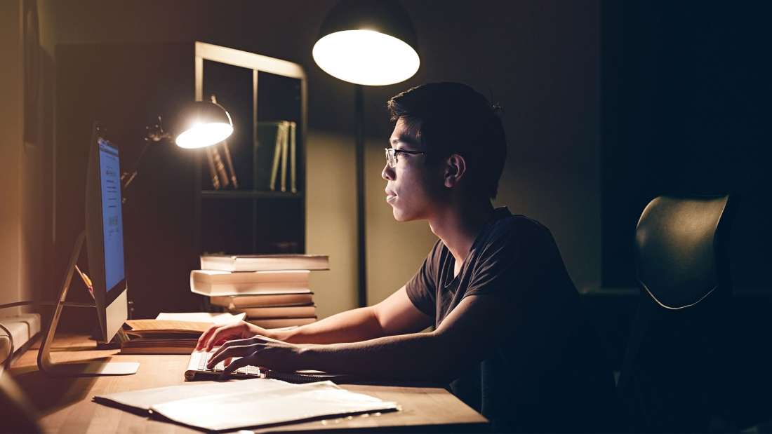 Man sitting at desk working on computer