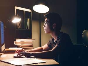 Man sitting at desk working on computer