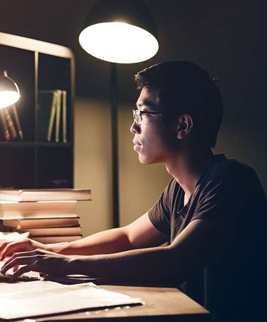 Man sitting at desk working on computer