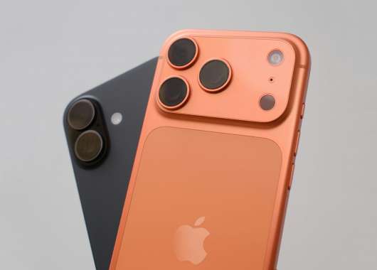 Photo of two iPhone 17s in black and orange colors.