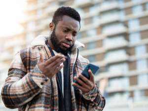 A man looking down at his phone.