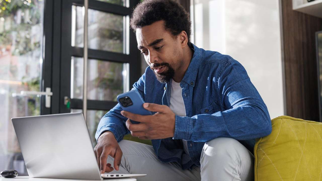 Man researching 888 area code number on laptop.