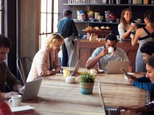 A busy cafe with many people connecting to Wi-Fi on laptops
