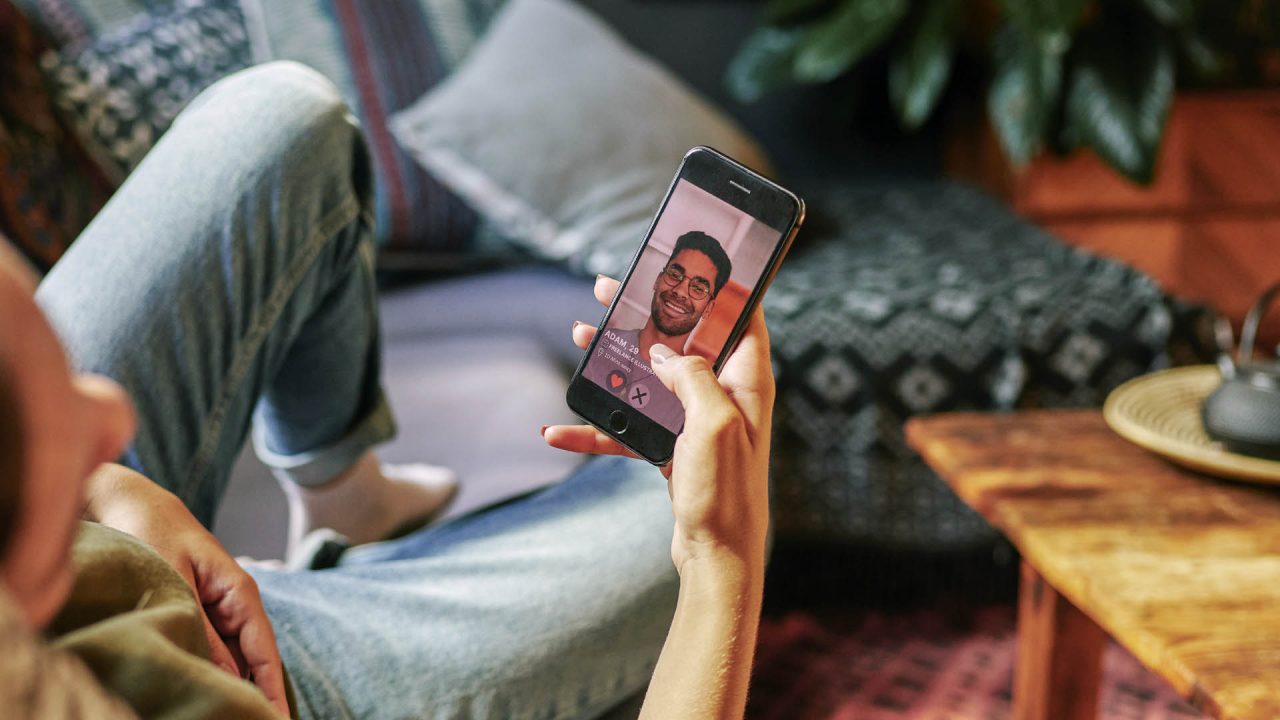 Stock photo of someone viewing a suspicious-looking dating profile.