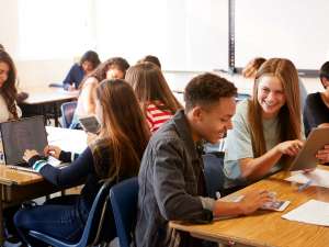 Teen students using edtech in a classroom